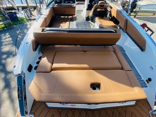 Slide: The Image of 2023 Cobalt R6 boat interior with tan leather seating and modern design. - 12