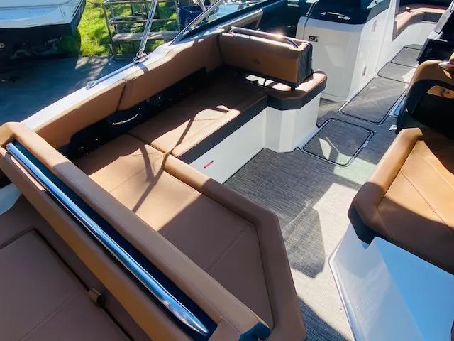 Slide: The Image of 2023 Cobalt R6 boat interior with tan leather seating and modern design. - 13