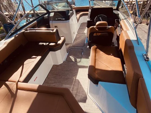 Slide: The Image of 2023 Cobalt R6 boat interior with brown leather seating and modern design. - 14