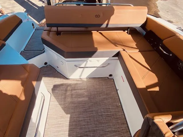 Slide: The Image of 2023 Cobalt R6 boat interior with tan leather seating and spacious layout. - 15