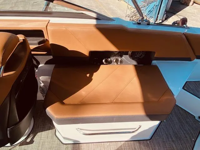 Slide: The Image of 2023 Cobalt R6 boat interior with tan leather seating and modern design. - 16