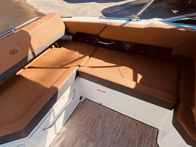 Slide: The Image of 2023 Cobalt R6 boat interior with tan leather seating and carpeted flooring. - 17