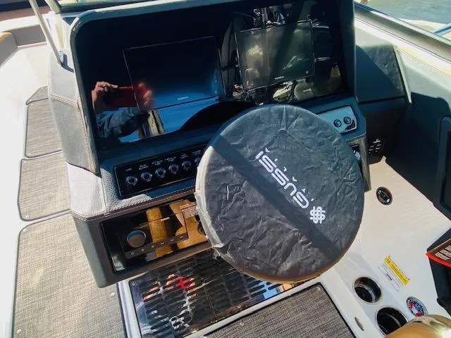 Slide: The Image of 2023 Cobalt R6 boat dashboard with covered steering wheel and electronic displays. - 21