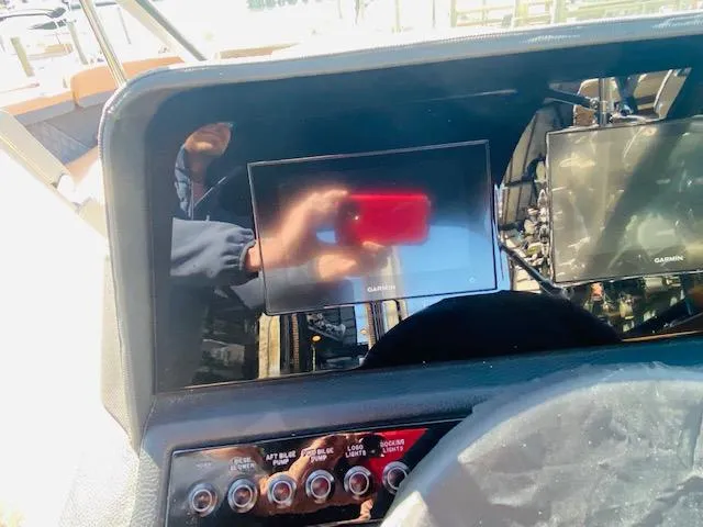 Slide: The Image of Dashboard of a 2023 Cobalt R6 boat with Garmin navigation screens. - 22