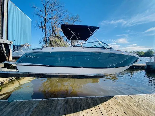 Slide: The Image of 2023 Cobalt R6 boat docked on a sunny day. - 28