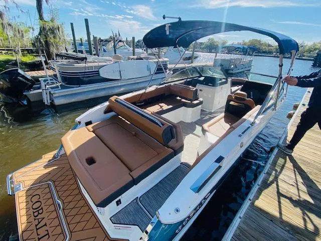 Slide: The Image of 2023 Cobalt R6 boat docked, featuring spacious seating and modern design. - 29