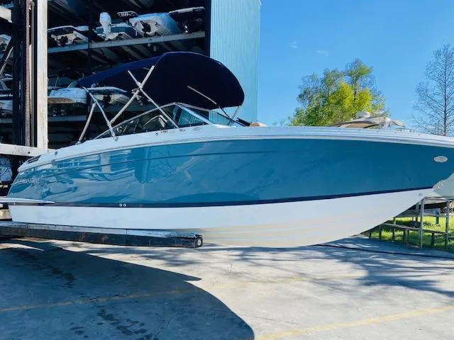 Slide: The Image of 2023 Cobalt R6 boat in blue, docked at a marina. - 3