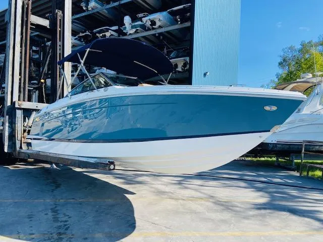 Slide: The Image of 2023 Cobalt R6 boat with blue hull and black canopy in storage facility. - 4