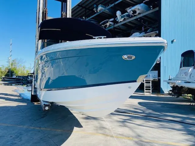 Slide: The Image of 2023 Cobalt R6 boat in blue and white, docked at a marina. - 5