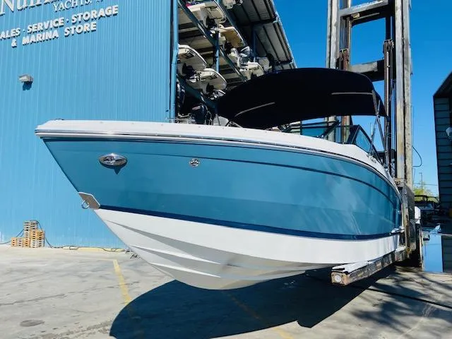 Slide: The Image of 2023 Cobalt R6 boat in blue, docked at a marina. - 6