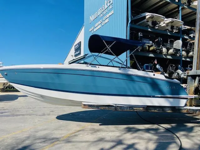 Slide: The Image of 2023 Cobalt R6 boat in blue and white, stored at a marina. - 7