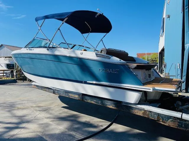 Slide: The Image of 2023 Cobalt R6 boat with blue hull and canopy on trailer. - 9
