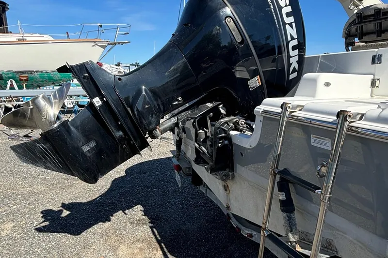 Slide: The Image of 2021 Sea Pro 219 boat with Suzuki outboard motor in a marina setting. - 10