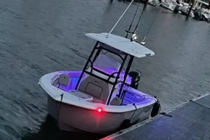 Slide: The Image of 2021 Sea Pro 219 boat docked at marina with illuminated interior. - 11