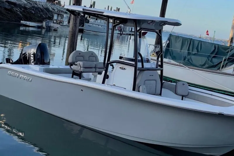 Slide: The Image of 2021 Sea Pro 219 boat docked in calm marina waters. - 4