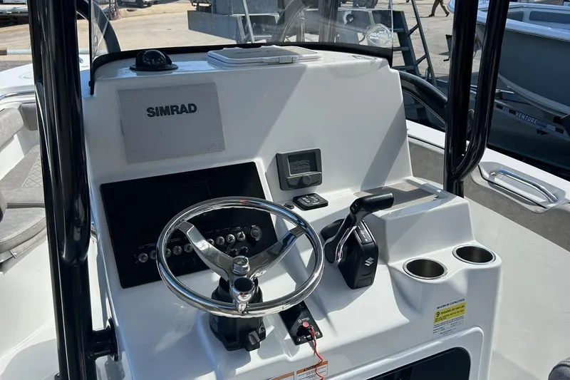 Slide: The Image of 2021 Sea Pro 219 boat console with Simrad electronics and steering wheel. - 5