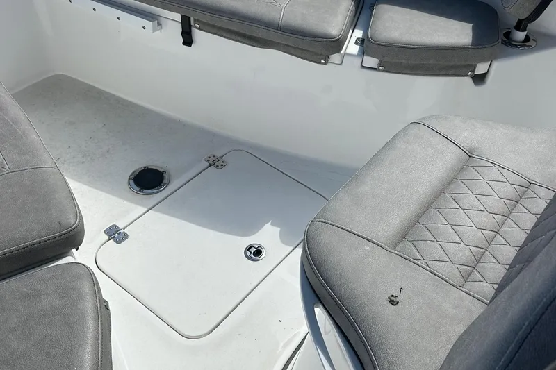 Slide: The Image of 2021 Sea Pro 219 boat interior with gray seating and storage hatch. - 7