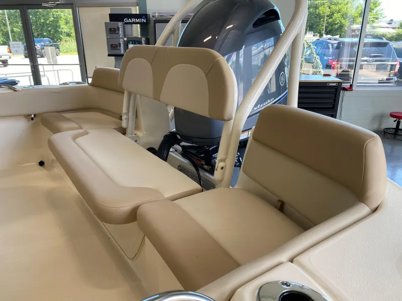 Slide: The Image of 2024 Scout 195 Dorado boat interior with beige seating and Yamaha outboard motor. - 2