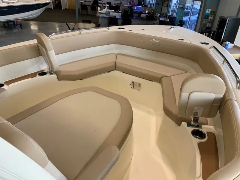 Slide: The Image of 2024 Scout 215 XSF boat interior with beige and white seating. - 11