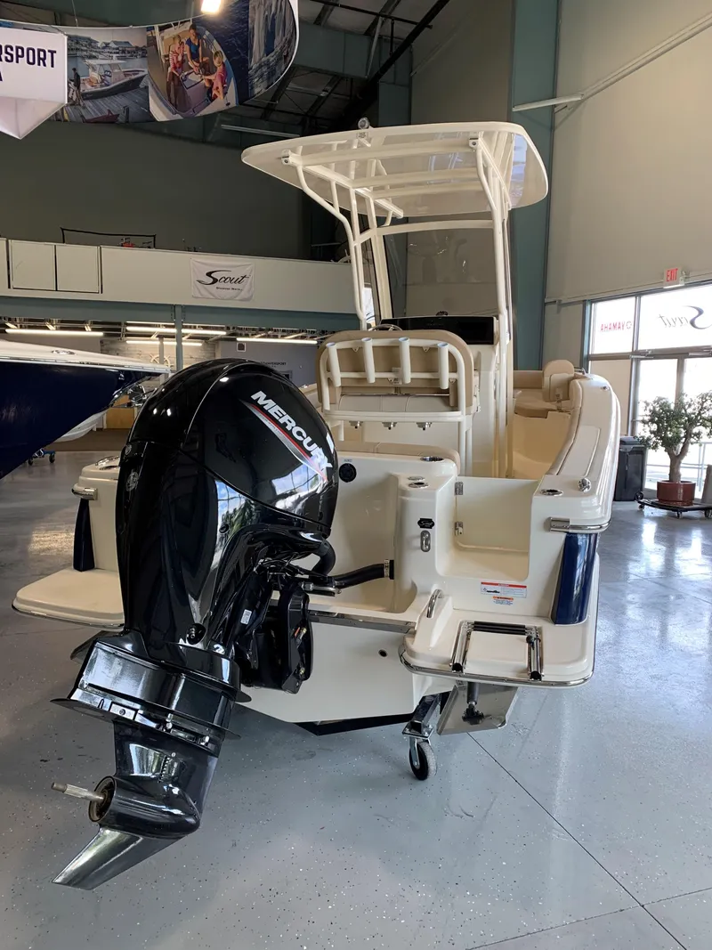 Slide: The Image of 2024 Scout 215 XSF boat in showroom, featuring sleek design and modern amenities. - 2