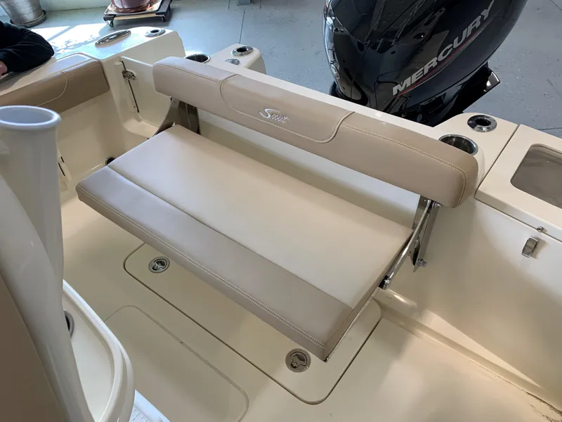 Slide: The Image of 2024 Scout 215 XSF boat with beige seating and Mercury outboard motor. - 7