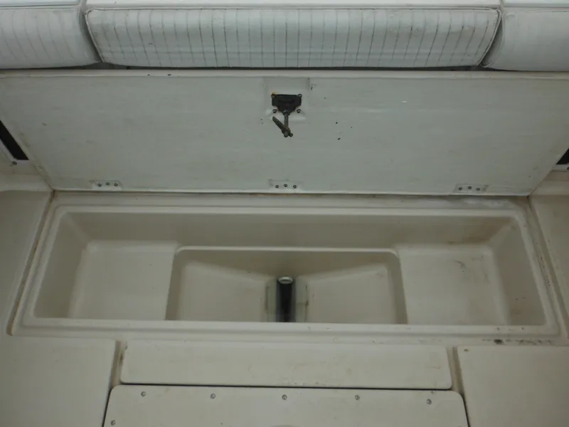 Slide: The Image of 1997 Robalo 2140 Walkaround boat storage compartment with open lid. - 14