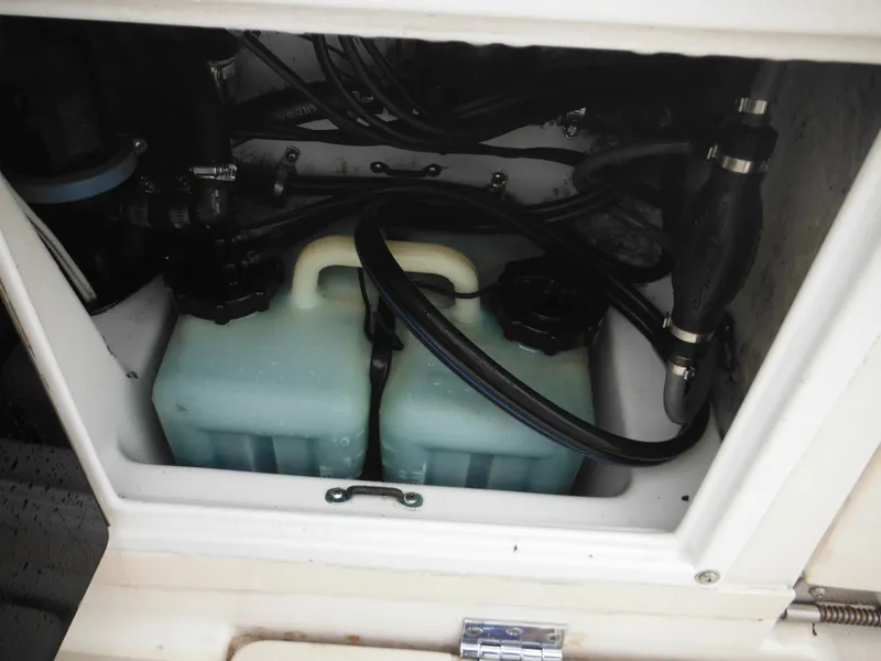 Slide: The Image of 1997 Robalo 2140 Walkaround boat engine compartment with fuel tanks and hoses. - 15