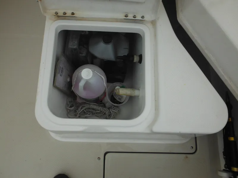 Slide: The Image of Storage compartment of a 1997 Robalo 2140 Walkaround boat with cleaning supplies. - 17