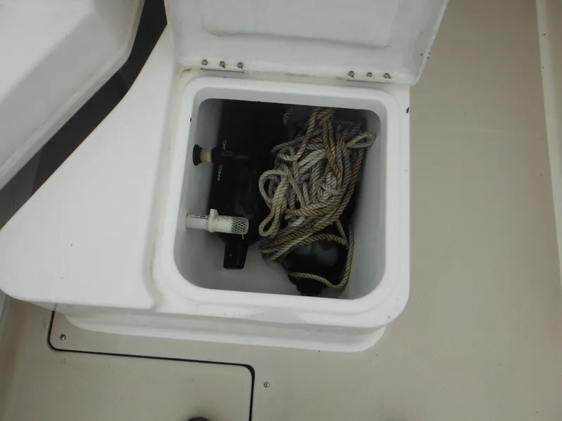 Slide: The Image of Storage compartment on a 1997 Robalo 2140 Walkaround boat with rope and equipment. - 18