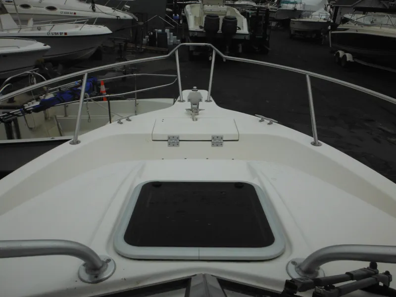 Slide: The Image of 1997 Robalo 2140 Walkaround boat deck with railing and hatch. - 19