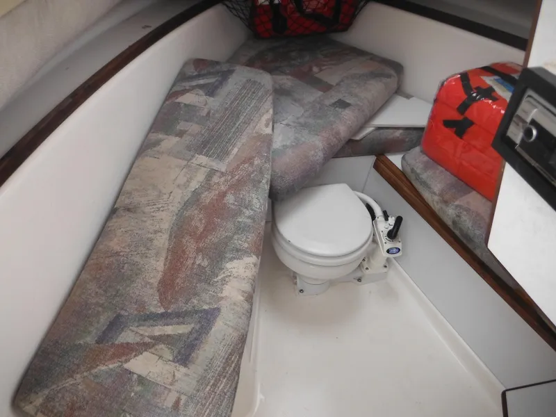 Slide: The Image of 1997 Robalo 2140 Walkaround cabin interior with seating and marine toilet. - 24