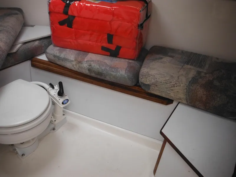 Slide: The Image of Interior of 1997 Robalo 2140 Walkaround boat with toilet and seating area. - 25