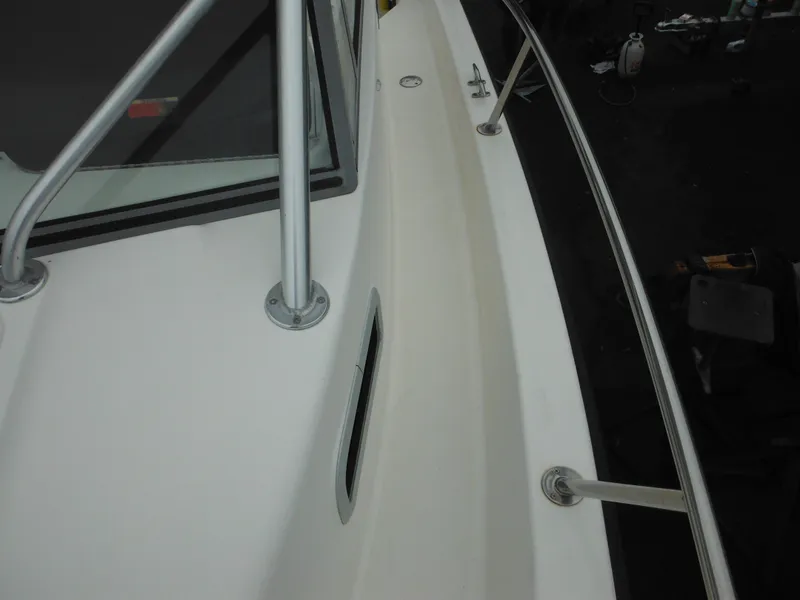 Slide: The Image of 1997 Robalo 2140 Walkaround boat deck with railing and window. - 33