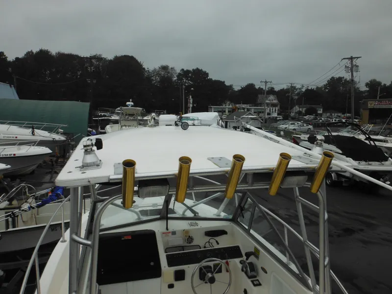 Slide: The Image of 1997 Robalo 2140 Walkaround boat with cockpit view and rod holders. - 38