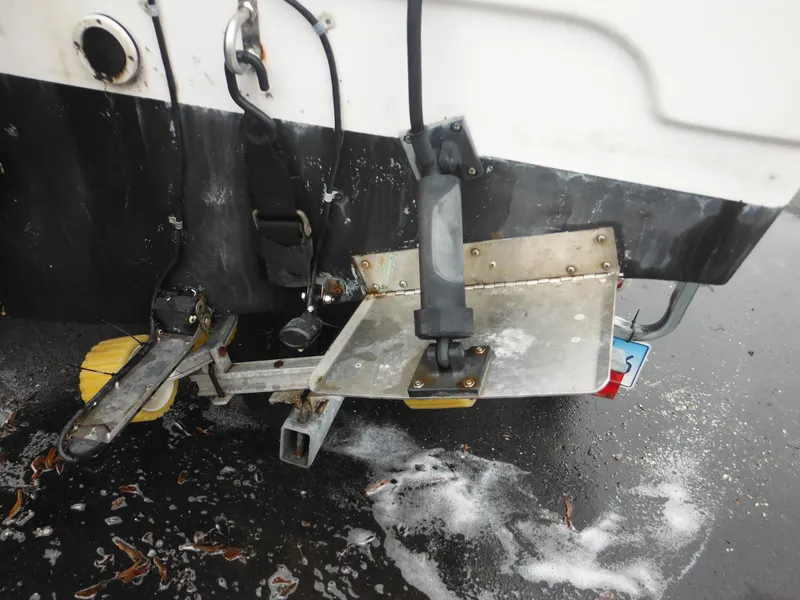 Slide: The Image of Close-up of the stern of a 1997 Robalo 2140 Walkaround boat with trailer attachment. - 39