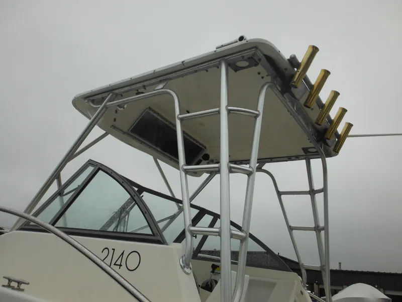 Slide: The Image of 1997 Robalo 2140 Walkaround boat with T-top and rod holders. - 5