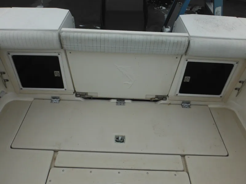 Slide: The Image of 1997 Robalo 2140 Walkaround boat stern with storage compartments and cushioned seating. - 9