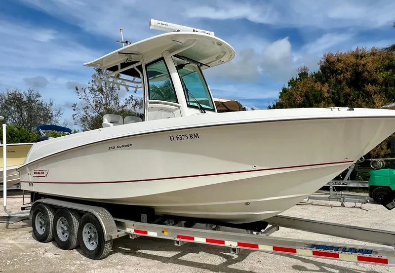 Slide: The Image of 2015 Boston Whaler 250 Outrage boat on a trailer, side view. - 1