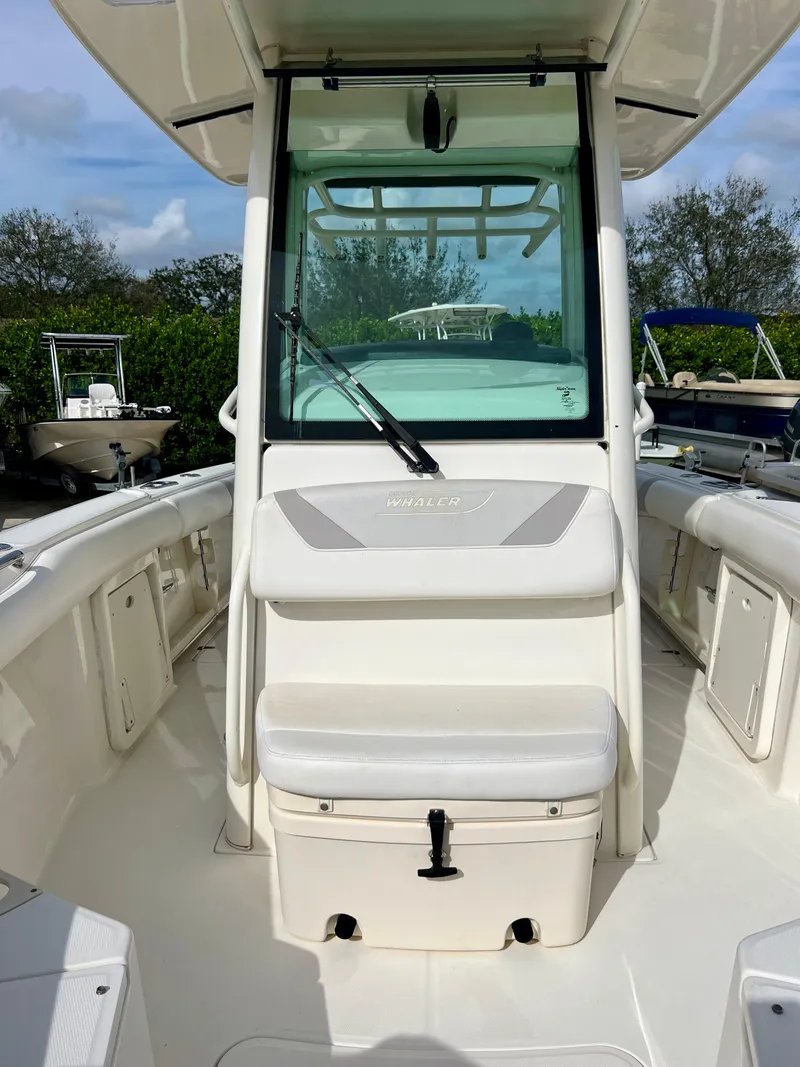 Slide: The Image of 2015 Boston Whaler 250 Outrage center console boat with seating and storage. - 14