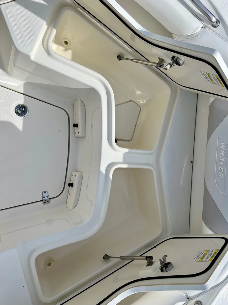 Slide: The Image of 2015 Boston Whaler 250 Outrage storage compartments open. - 15