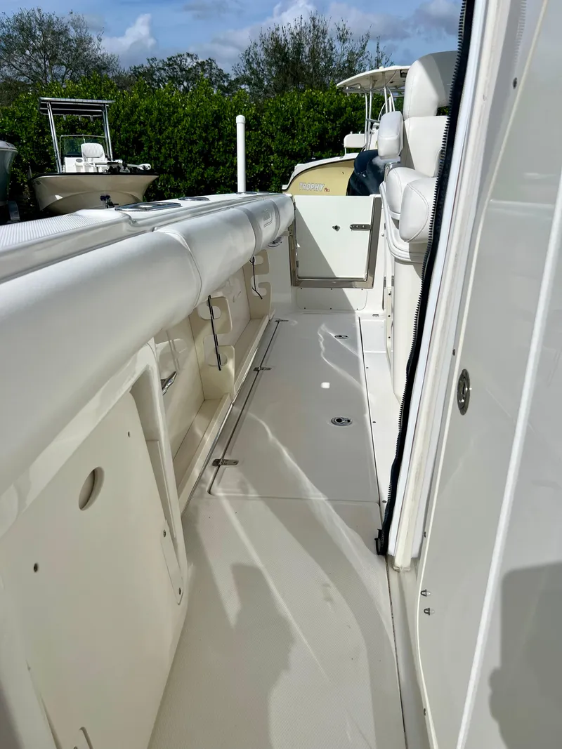 Slide: The Image of 2015 Boston Whaler 250 Outrage boat deck with seating and storage compartments. - 16
