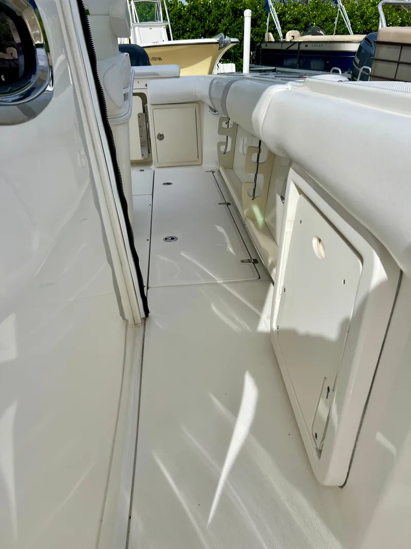 Slide: The Image of 2015 Boston Whaler 250 Outrage boat interior with storage compartments. - 17