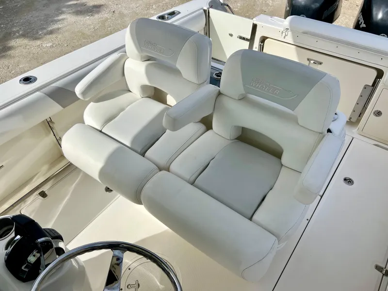 Slide: The Image of 2015 Boston Whaler 250 Outrage boat with dual white cushioned seats. - 18