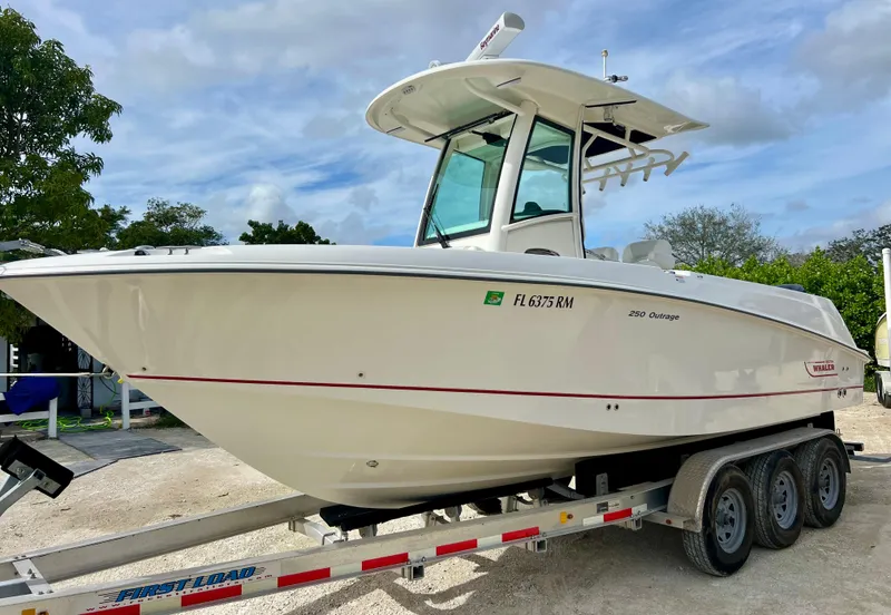 Slide: The Image of 2015 Boston Whaler 250 Outrage boat on a trailer, side view. - 2