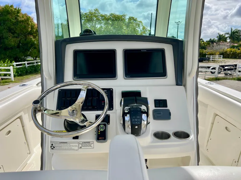 Slide: The Image of 2015 Boston Whaler 250 Outrage boat helm with dual screens and steering wheel. - 20