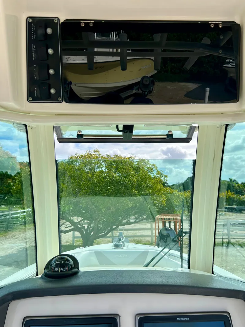 Slide: The Image of 2015 Boston Whaler 250 Outrage boat cockpit view with navigation equipment. - 21