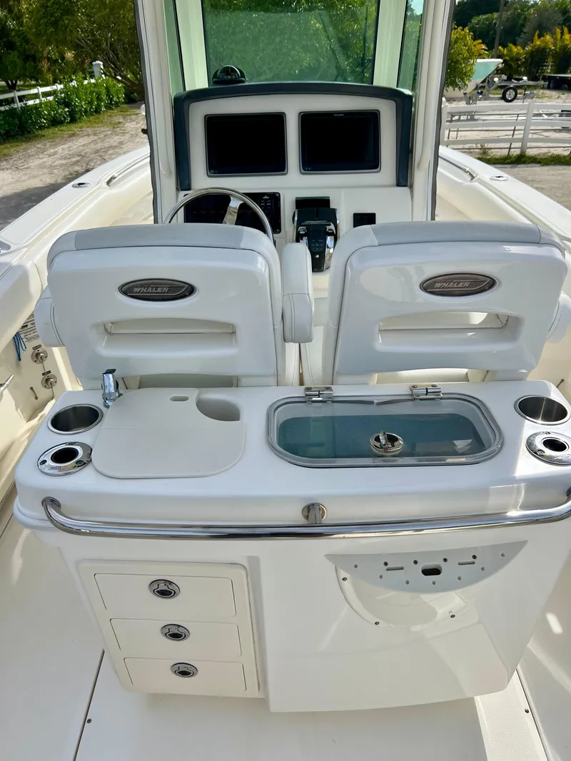 Slide: The Image of 2015 Boston Whaler 250 Outrage boat interior with dual seats and control panel. - 25