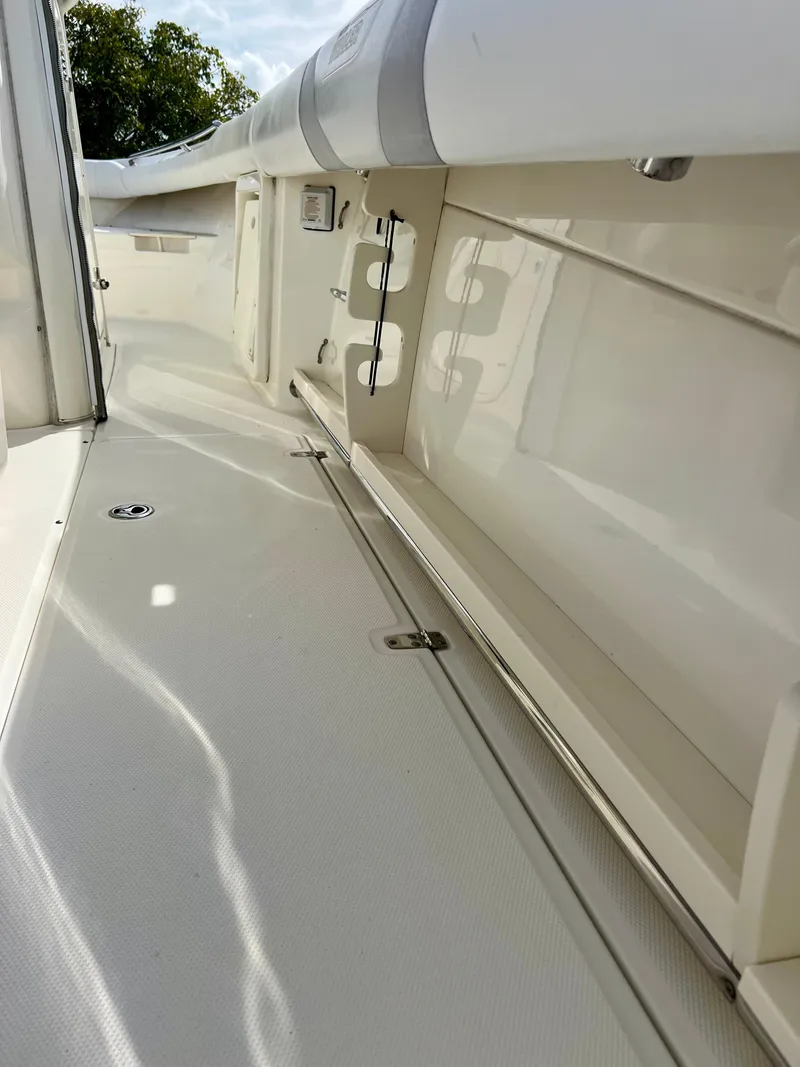 Slide: The Image of 2015 Boston Whaler 250 Outrage boat interior, white deck and seating. - 27