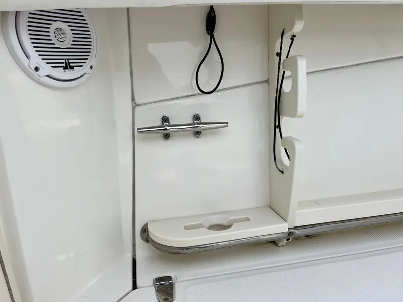 Slide: The Image of 2015 Boston Whaler 250 Outrage boat interior detail with speaker and storage. - 28
