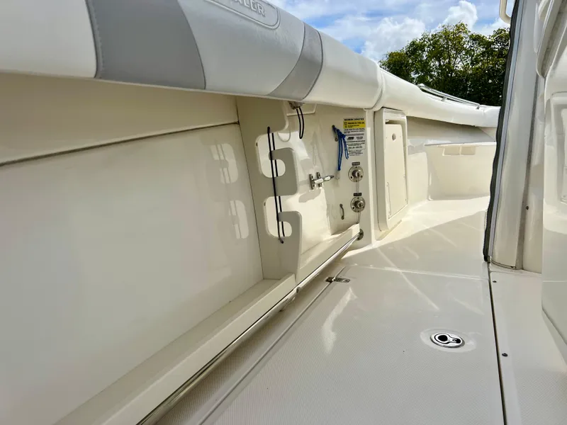 Slide: The Image of 2015 Boston Whaler 250 Outrage boat deck with storage compartments and fishing rod holders. - 29